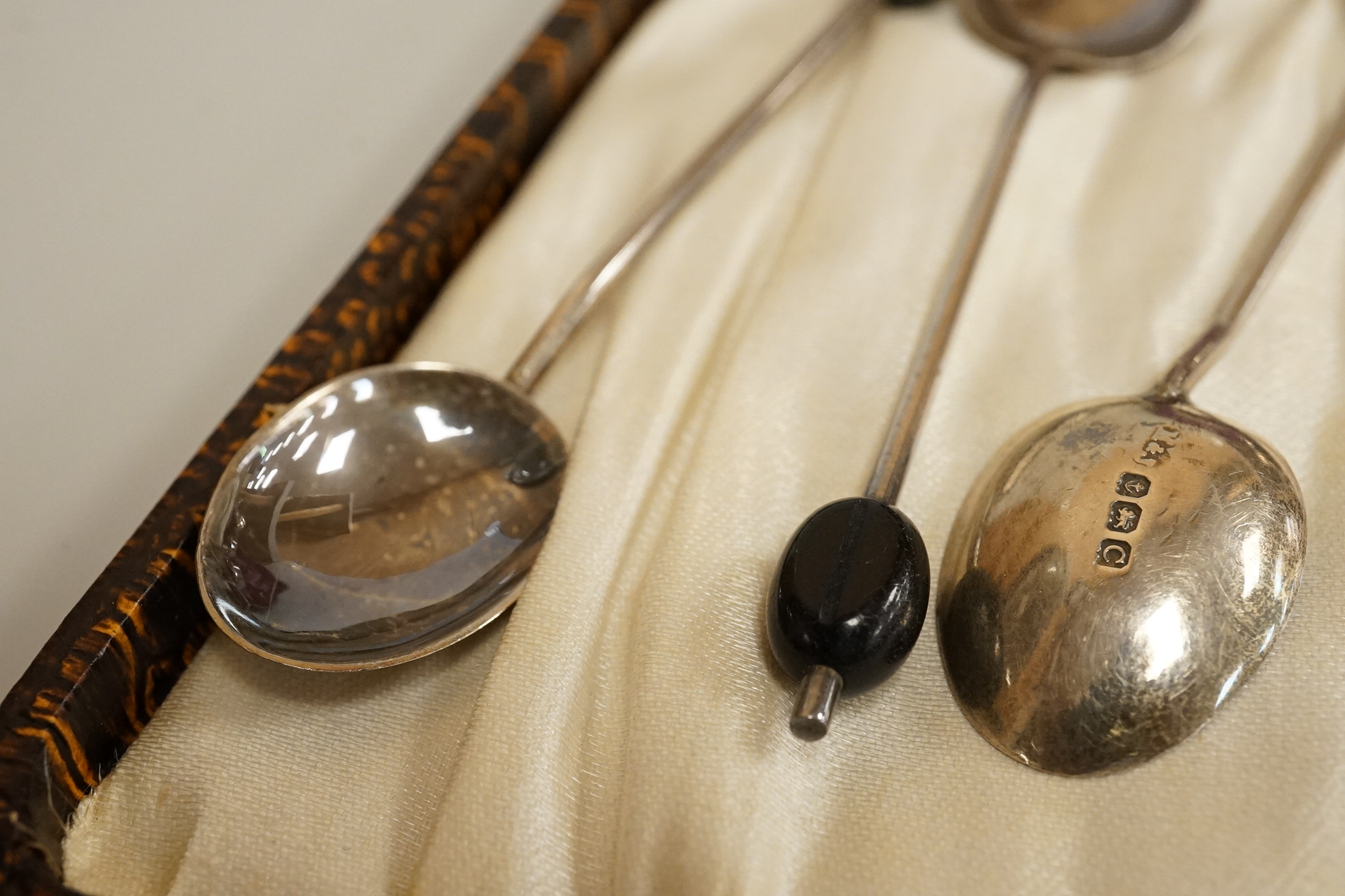 A cased pair of Victorian silver circular salts, by Edward Hutton, London, 1886, lacking spoons, together with a cased set of six silver bean end coffee spoons, a cased silver spoon, a small silver 'Dunlop Golf Ball Hole
